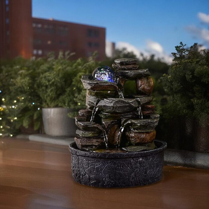 Джерело води Zen'Light від Zimmerbrunnen: природний водоспад з ефектом каменів та кольоровим LED-підсвічуванням. Ідеальна декор для дому, медитації та релаксації. Об'єкт Фен-Шуй для щастя. Висота 23 см (Satya)